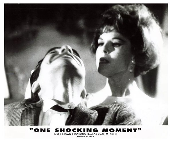 Fetish movie still from 1965 'One Shocking Moment' features a dominant woman taking charge of a man and pulling his hair Fetish movie still from 1965 'One Shocking Moment' features a dominant woman taking charge of a man and pulling his hair