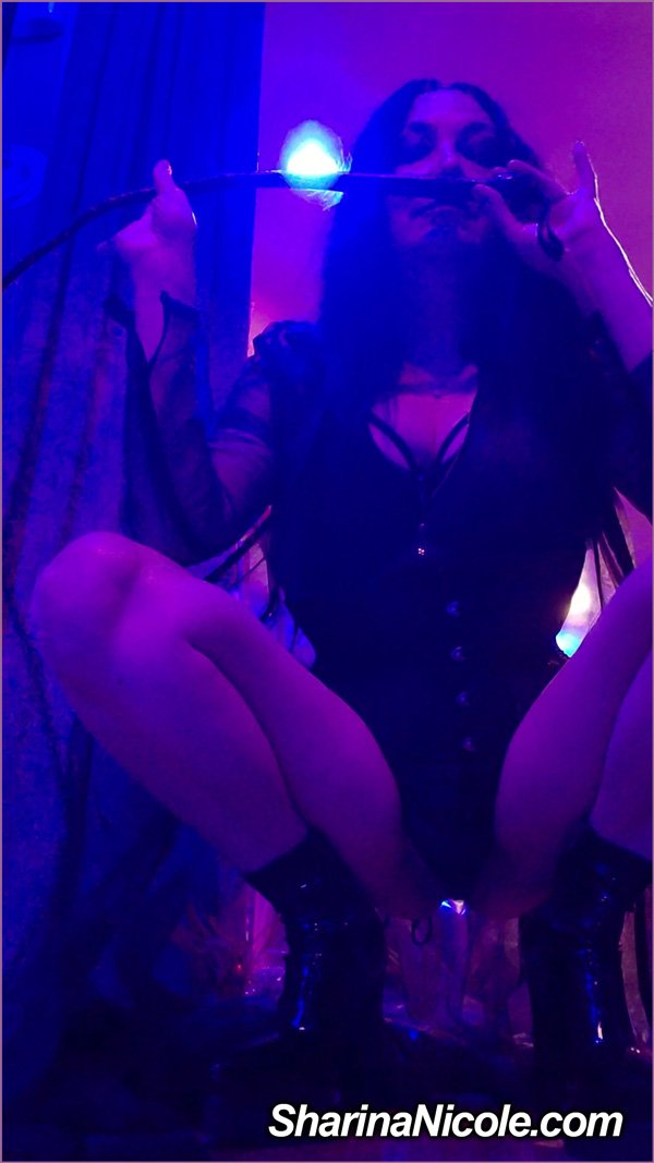 Femdom Dominatrix Mistress Sharina Nicole's mysterious allure as she crouches down holding one of her single tail whips Femdom Dominatrix Mistress Sharina Nicole's mysterious allure as she crouches down holding one of her single tail whips