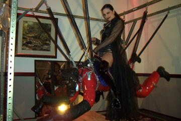 Mistress Sharina Nicole riding Mistress Amanda Wildefyre 's Charger Pony at the Midwest Fetish Spring Sting 2002 BDSM convention in Moundsview, Minnesota